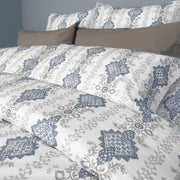Della bedding set close-up showing 100% long-staple cotton quality and embroidered design